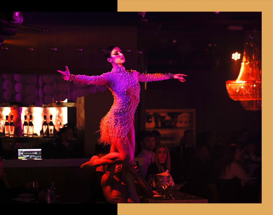 beauty dancer stand up in arms of male dancer during live show at the restaurant gatsby barcelona